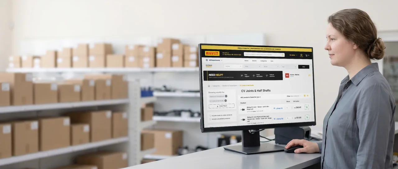 Auto parts counter clerk at the computer; the monitor shows the Pirelli Conecta catalog with the number of stores for each part.